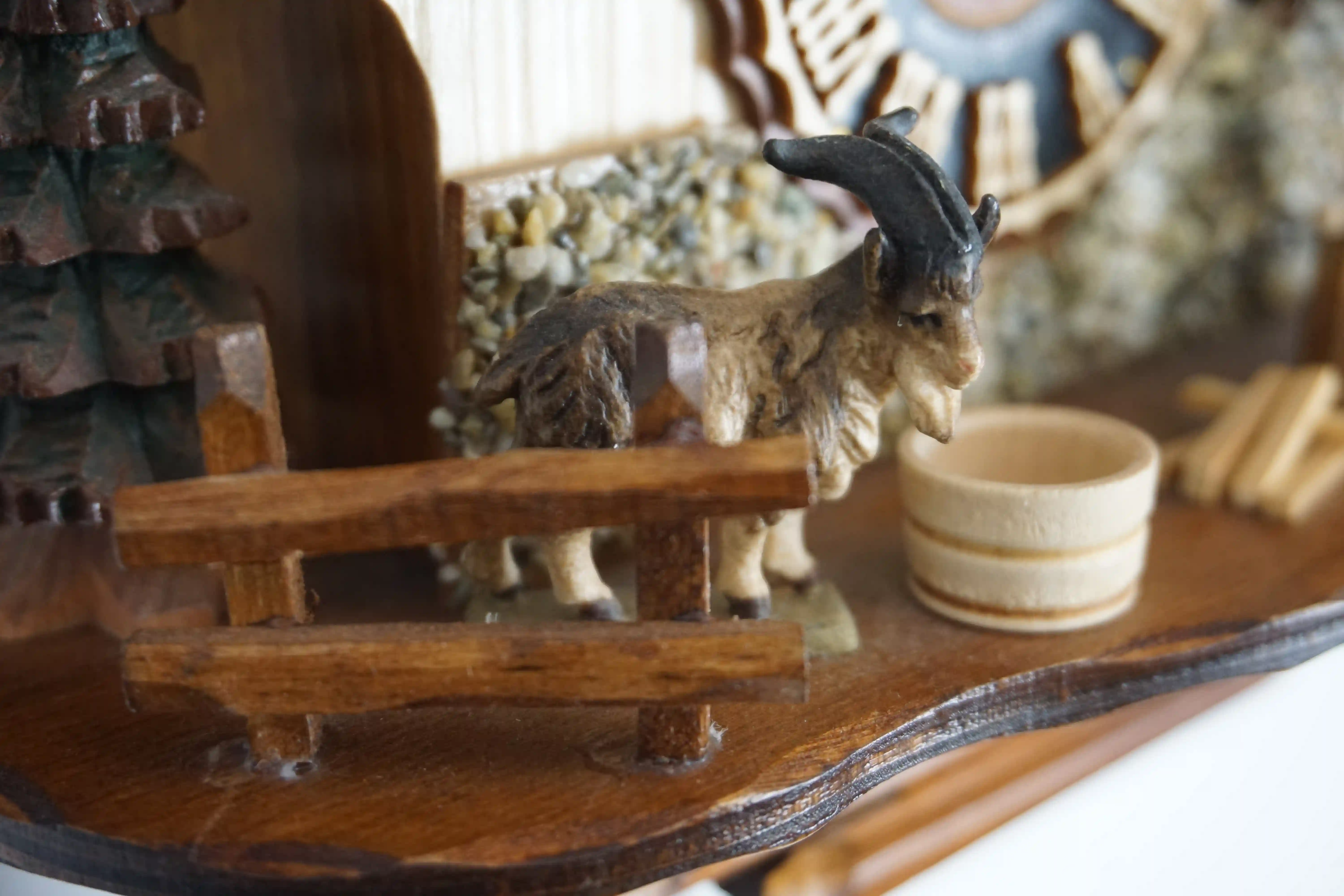 Cuckoo Clock  Wood Chopper  1 Day Movement (5) Small mechanical black forest cuckoo clock, chalet house decorated with a real stones with wood chopper and a nicely carved goat, made by Hönes