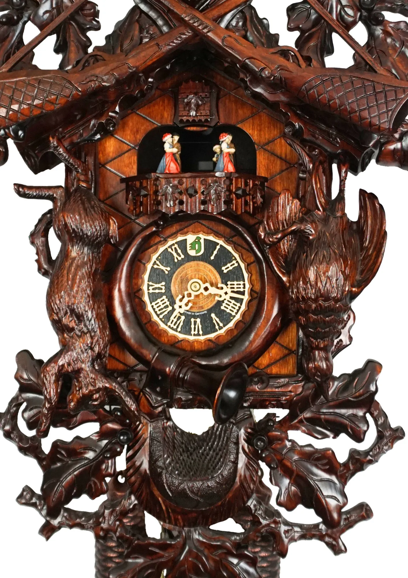 Cuckoo Clock  Hunter Clock  8 Day Movement  Music (2) Beautifuly hand carve black forest huting themed cuckoo clock in brown color, decorated with the trophy deer head, guns, phasan and the rabbit. The clocks dial is wrapped with the hunting horn and beneath it hangs the haunting pouch. Made by Hönes