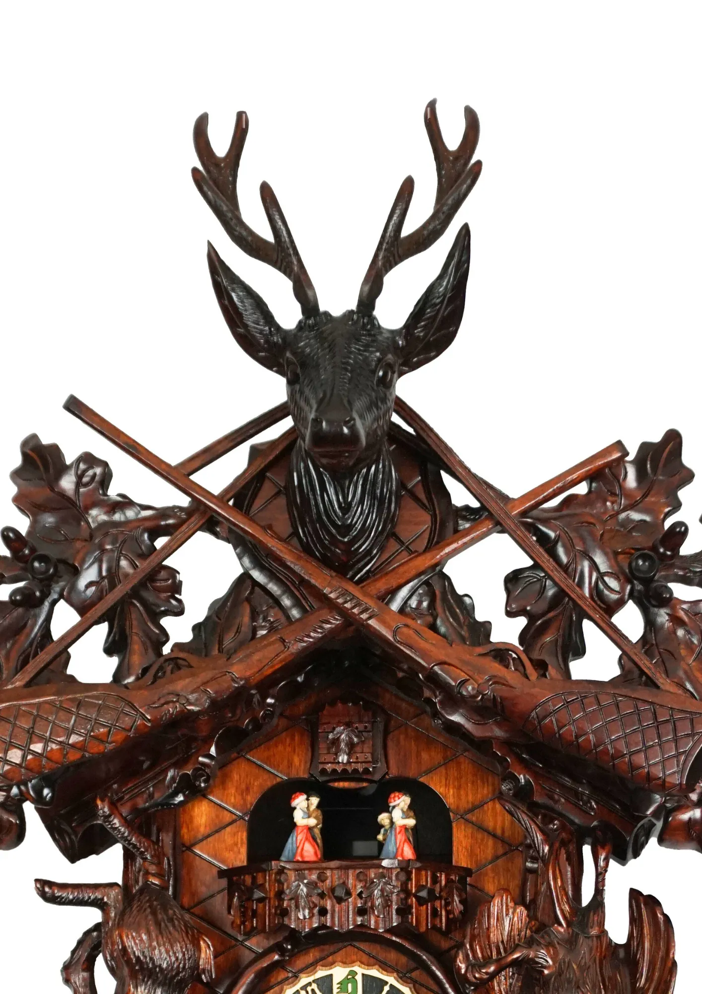 Cuckoo Clock  Hunter Clock  8 Day Movement  Music (3) Beautifuly hand carve black forest huting themed cuckoo clock in brown color, decorated with the trophy deer head, guns, phasan and the rabbit. The clocks dial is wrapped with the hunting horn and beneath it hangs the haunting pouch. Made by Hönes