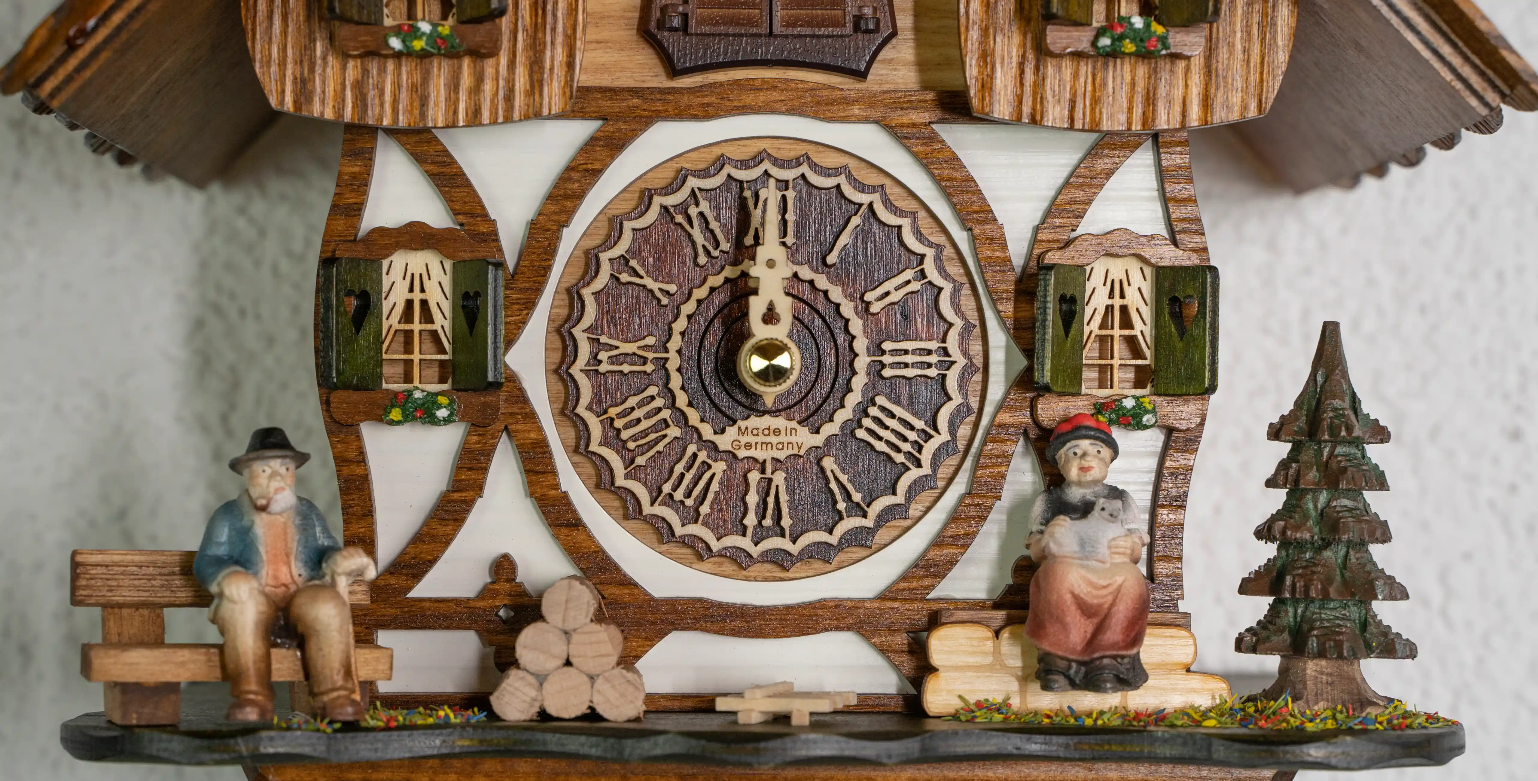 Cuckoo Clock  Black Forest Couple  Battery (5) Battery cuckoo clock with a black forest couple in front of the chalet house plays music made by Trenkle Uhren
