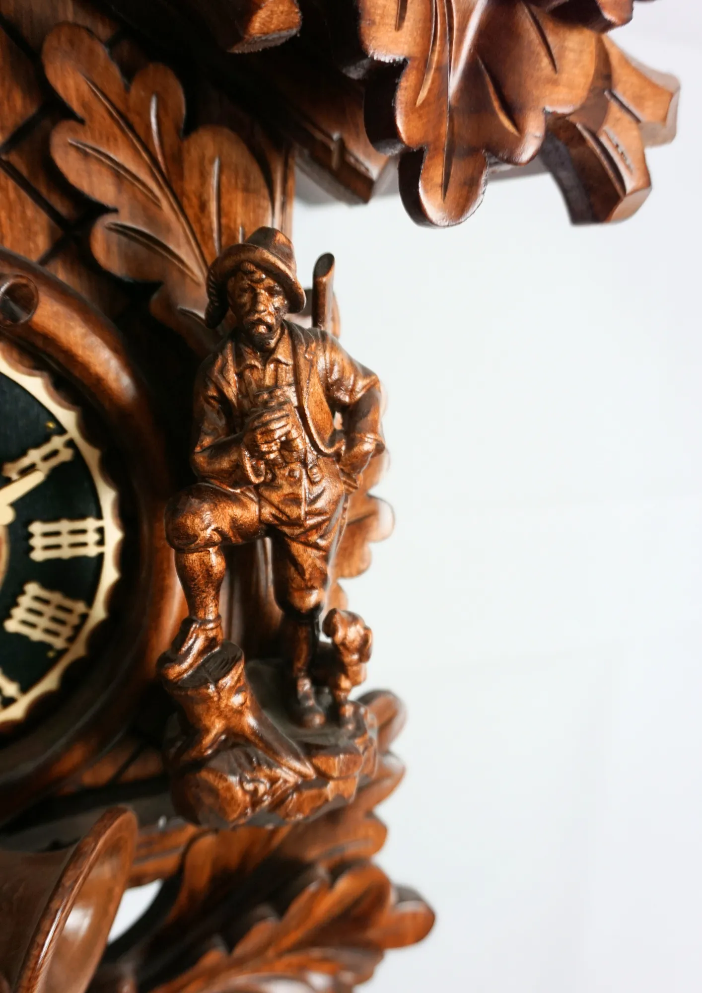 Cuckoo Clock  Hunter Clock  8 Day Movement (4) Hand carved authentic mechanical brown black forest cuckoo clock in a hunter theme. Precisely carved deer head is decorating the top while there is a hunter and a falcon figure on the sides of the clock. The clocks dial is wraped with a hunting horn while