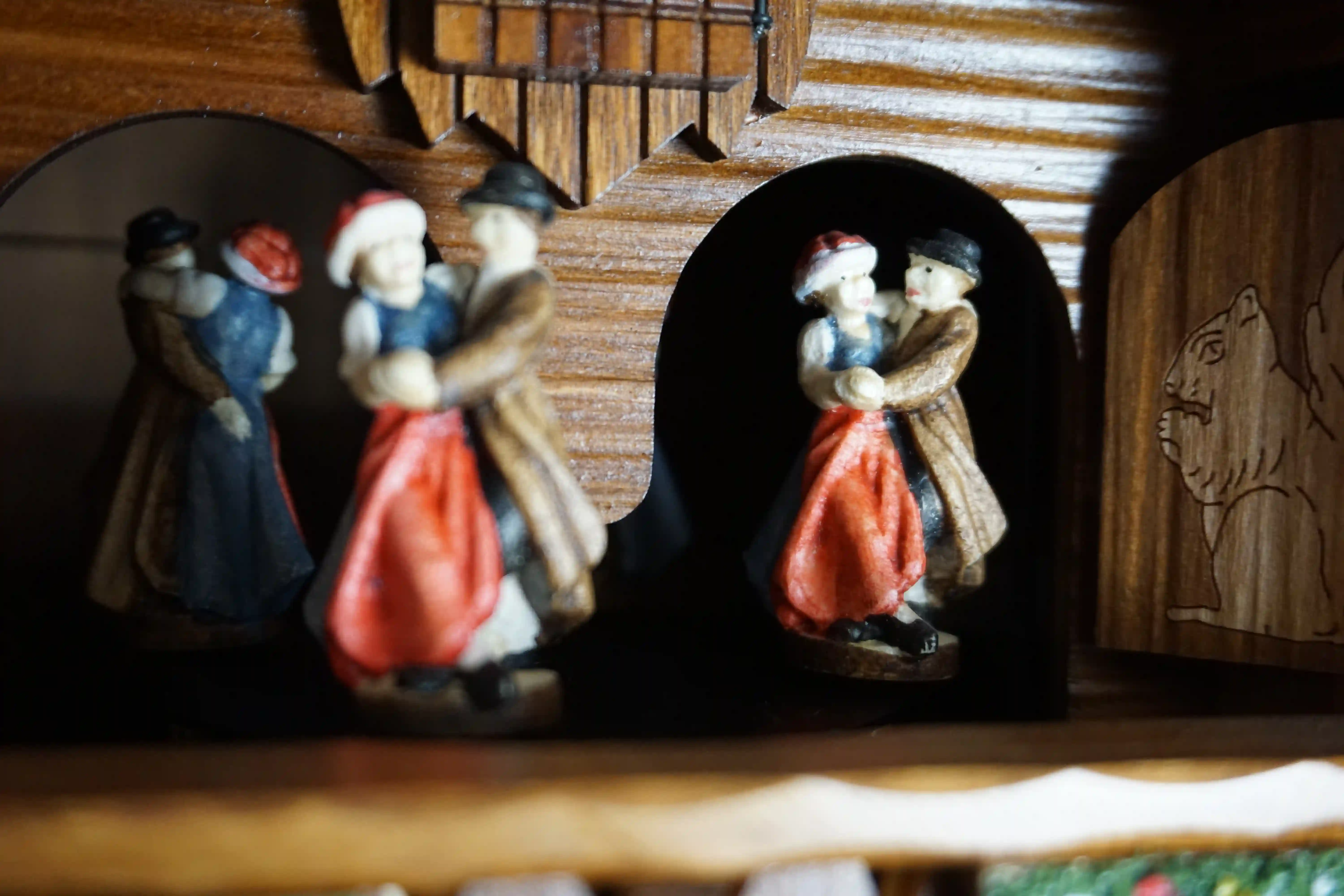 Cuckoo Clock  Honeymoon  8 Day Movement with Music (7) Large authentic chalet colorful black forest cuckoo clocks decorated to the finest detail. Represents a black forest couple on their honeymoon sitting on the bench in front of the shingle roof house. As the music plays the couple is kissing, water wheel t