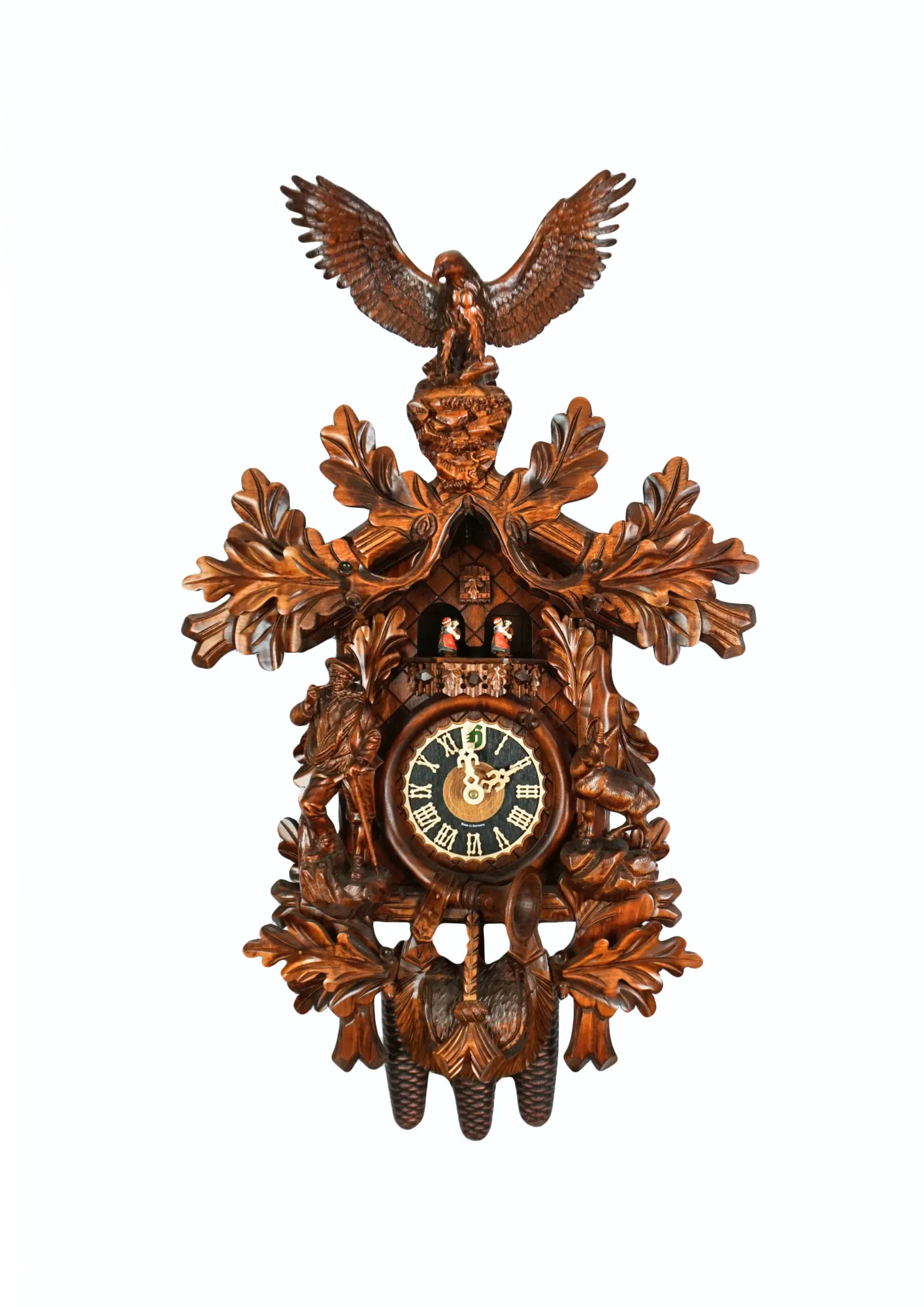 Precisely hand carved wildlife mechanical brown tradtional black forest clock, decorated with a majestic eagle, mountain goat and the rock climber. The clock plays music on the full hour and the dancers turn. This is one of the nicest tradtional cuckoo cl