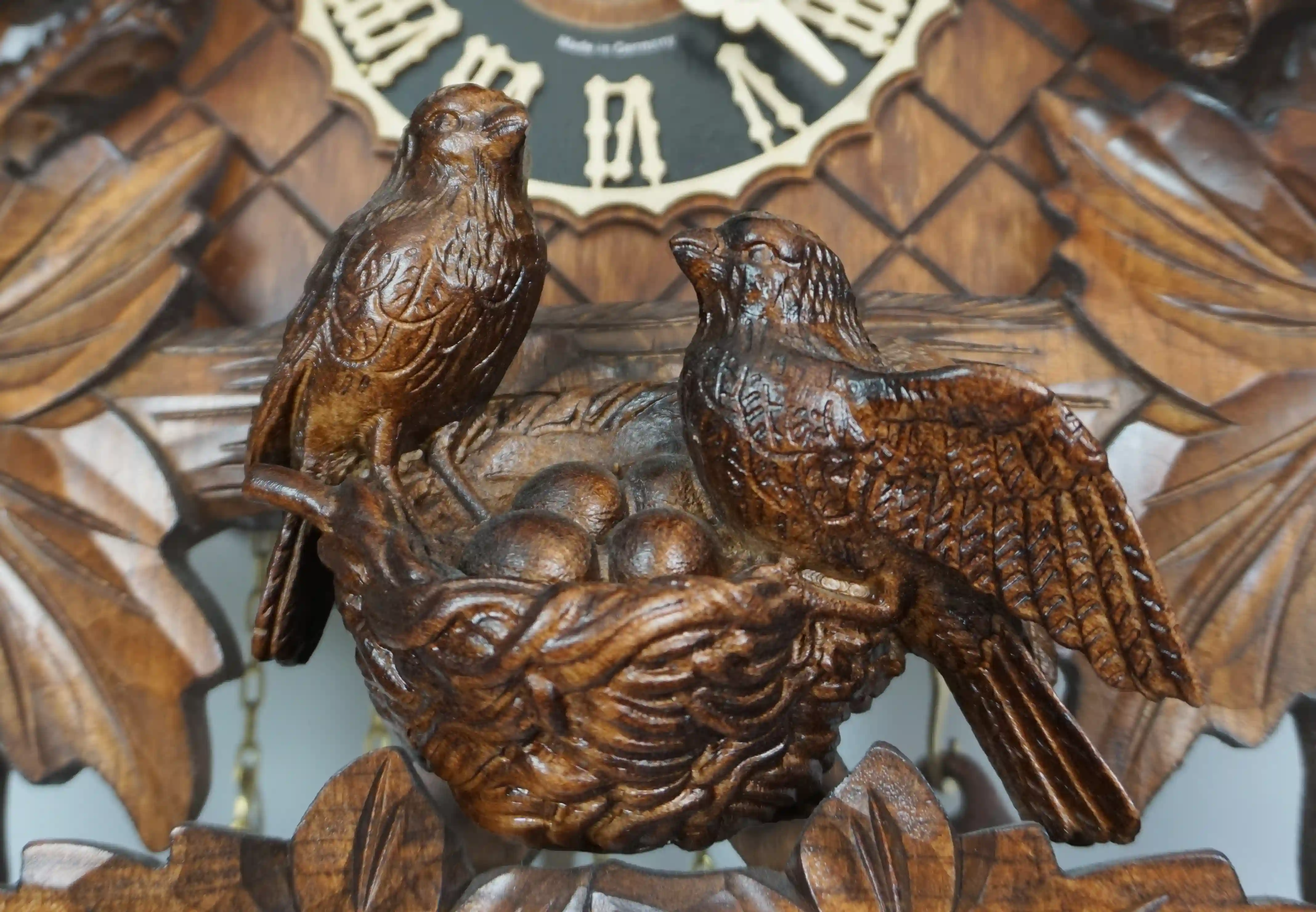 Cuckoo Clock  Birds Nest  8 Day Movement with Music (5) Authentic lager mechanical 8 day brown traditional black forest cuckoo clock hand carved to the finest detail. Decorated with five bird carvings and their nest with the offspring, this clocks represents the brid nest and wildlife in Black Forest. Made by