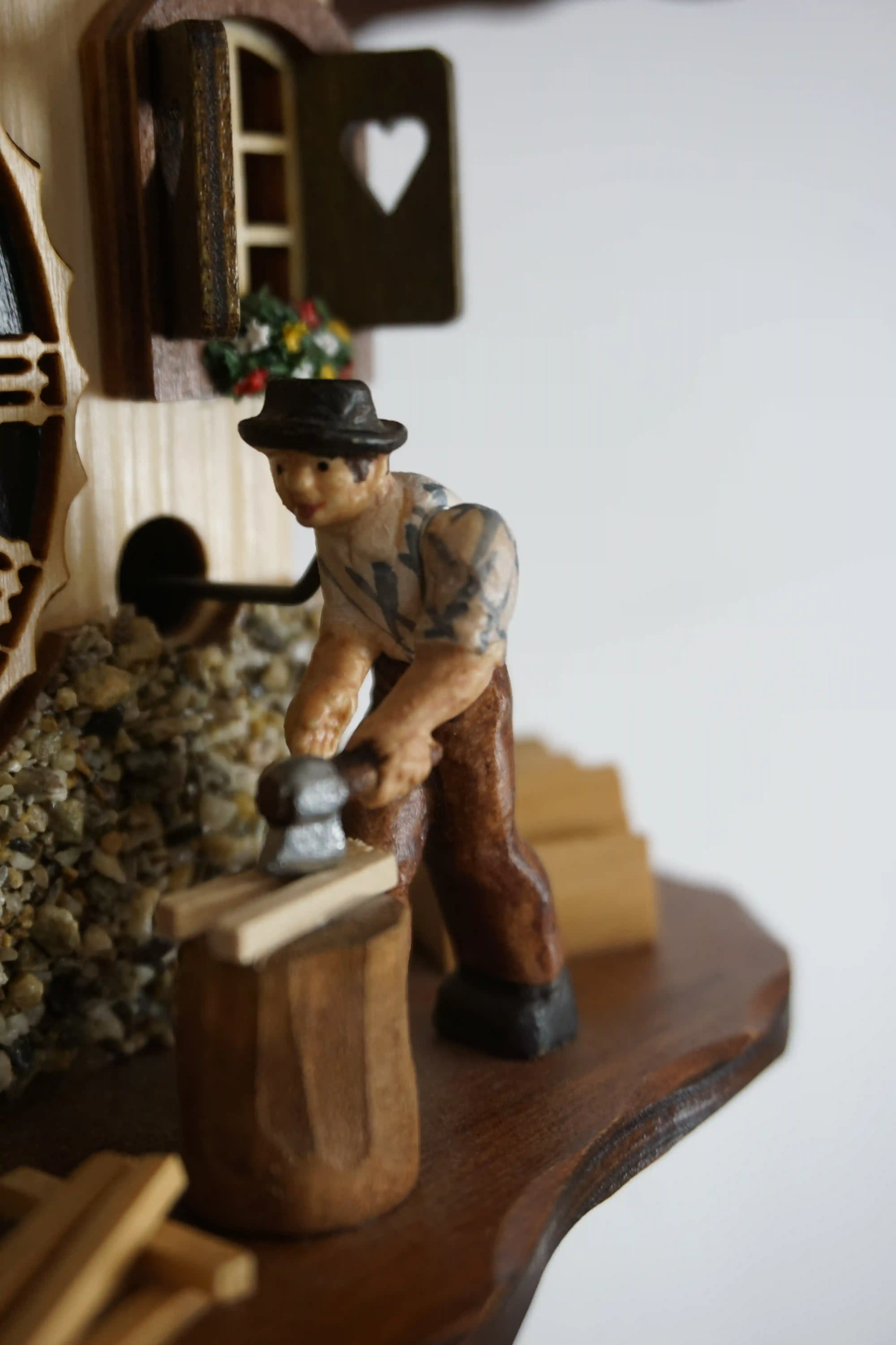 Cuckoo Clock  Wood Chopper  1 Day Movement (4) Small mechanical black forest cuckoo clock, chalet house decorated with a real stones with wood chopper and a nicely carved goat, made by Hönes