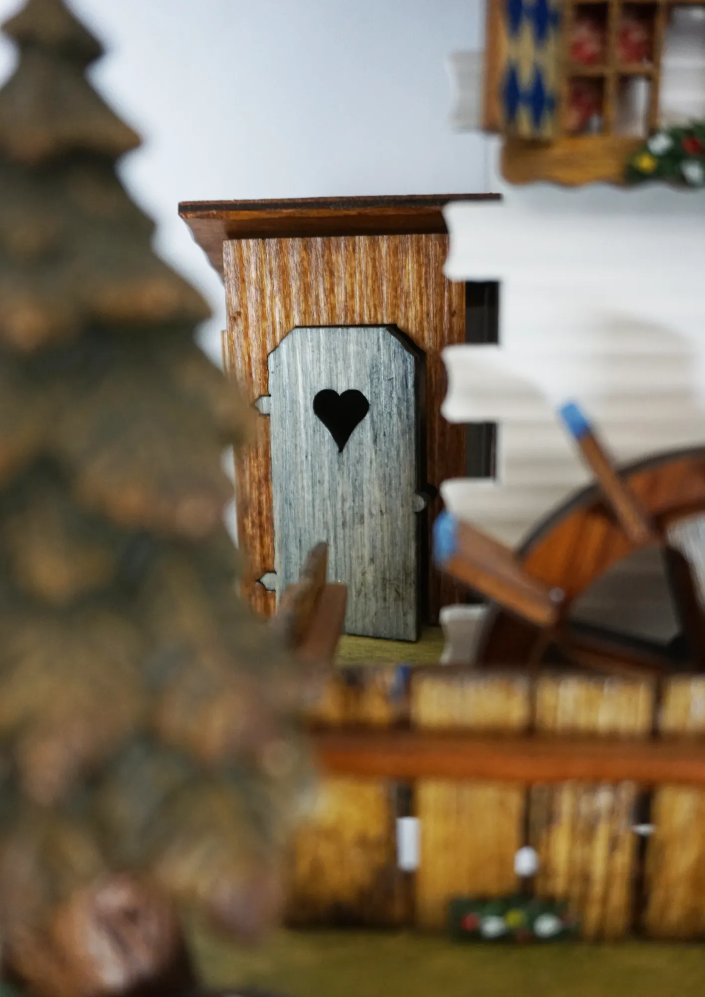 Cuckoo Clock  The Beer Garden  8 Day Movement with Music (3) Bavarian-style house to celebrate the infamous Oktoberfest. Blue and white shutters on the windows represent Bavaria. Around the clock, there are two men drinking beer and a lady wearing a dirndl dress, serving. The cuckoo calls every half hour and plays