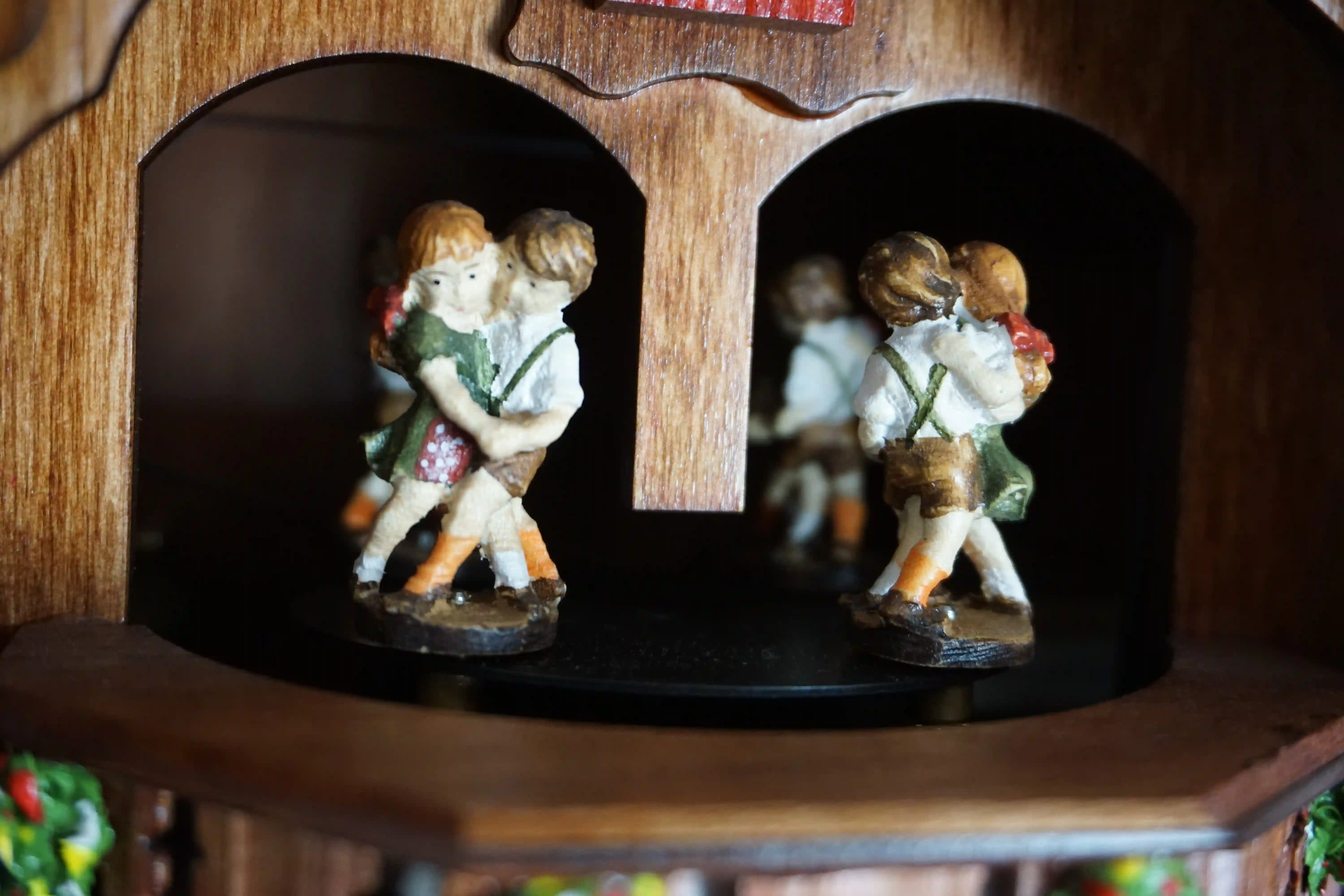 Cuckoo Clock  Kissing Kids  8 Day Movement with Music (8) Chalet shingle roof mechanical black forest cuckoo clock with presice attention to detail. The kids are turning their heads and kissing, water wheel turns and the dancers are dancing as the music is playing