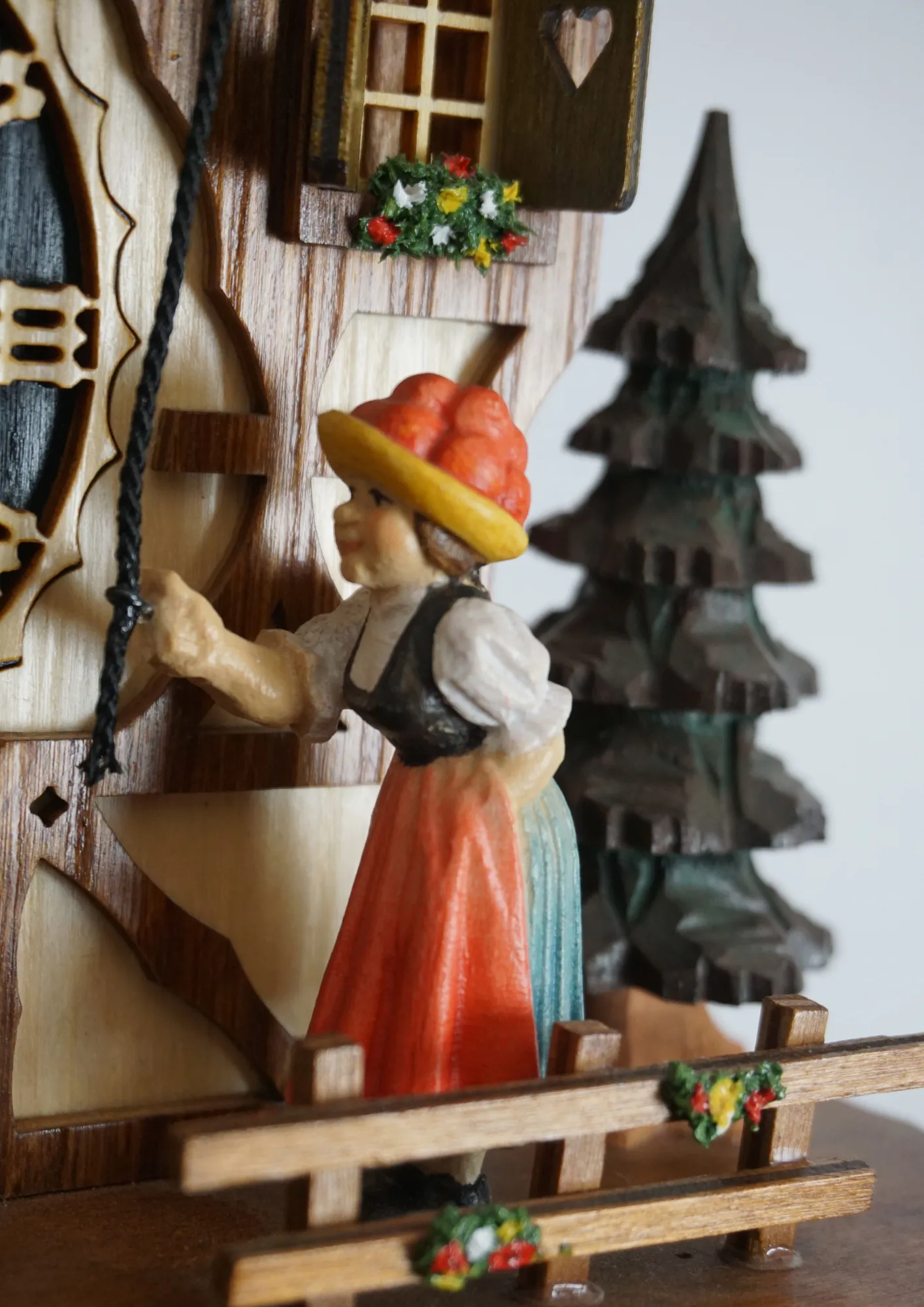 Cuckoo Clock  Bell Ringer  8 Day Movement (4) Chalet authentic black forest cuckoo clock with a bell ringer lady wearing traditional black forest dress and the red bolenhut, which means she is single lady. Black bolenhut represent married ladies. Colorful made by Hönes