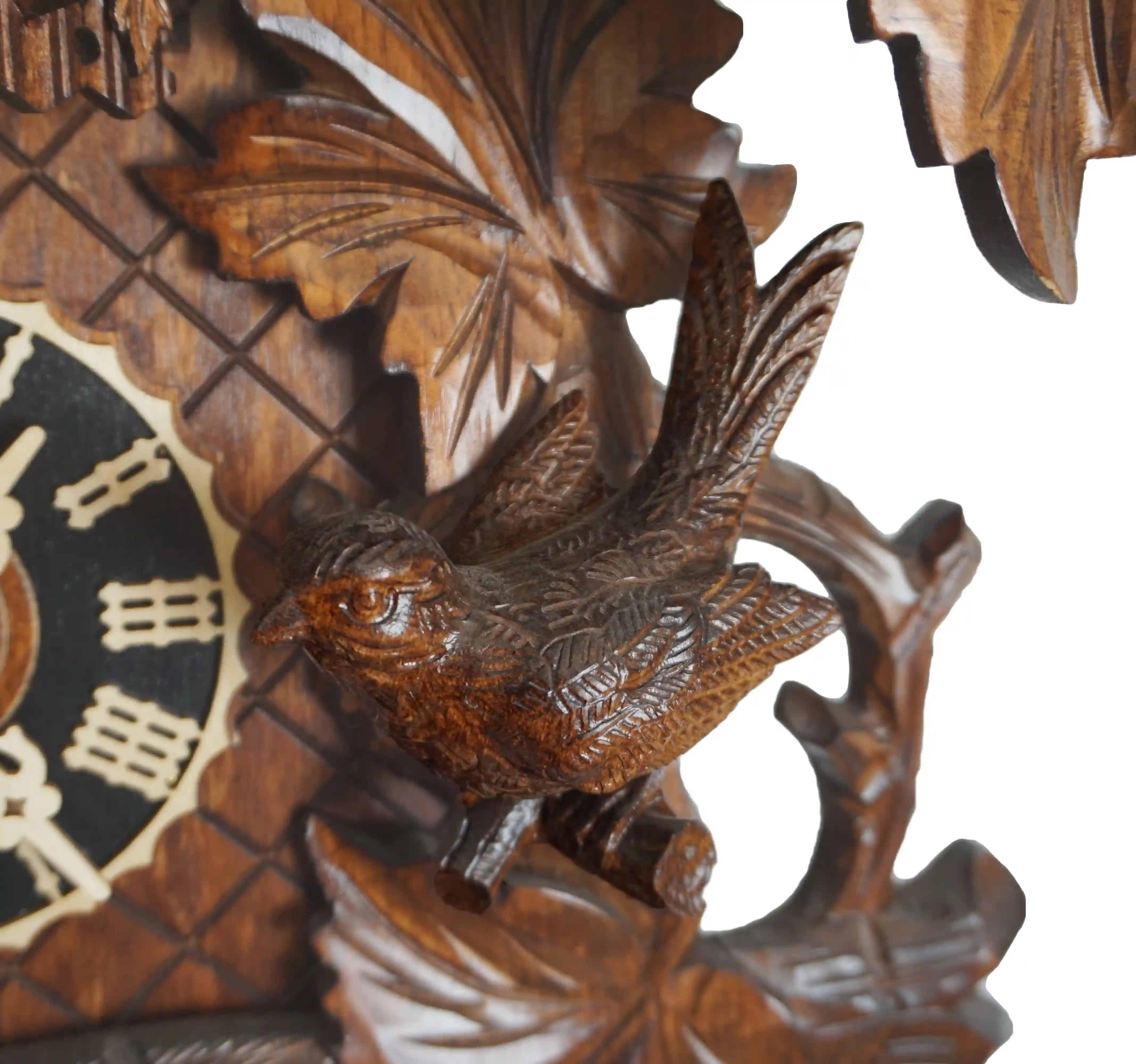 Cuckoo Clock  Birds Nest  8 Day Movement with Music (4) Authentic lager mechanical 8 day brown traditional black forest cuckoo clock hand carved to the finest detail. Decorated with five bird carvings and their nest with the offspring, this clocks represents the brid nest and wildlife in Black Forest. Made by
