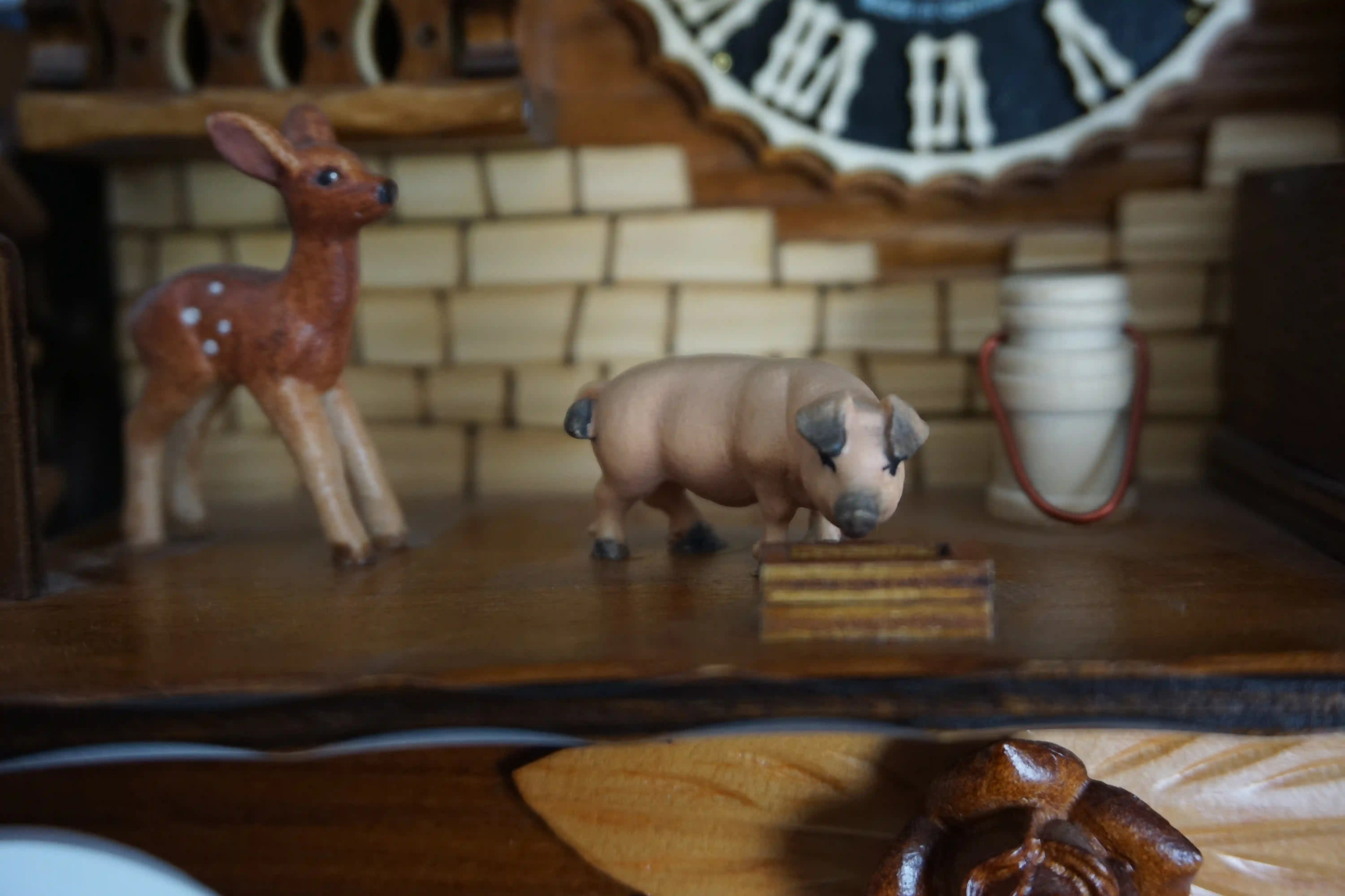 Cuckoo Clock  Honeymoon  1 Day Movement with Music (5) Mechanical black forest cuckoo clock decorated to the finest detail, representing a couple on honeymoon sitting on the bench in front of the chalet house sliding thowards each other for a kiss while the music plays, dancers and waterwheel turn