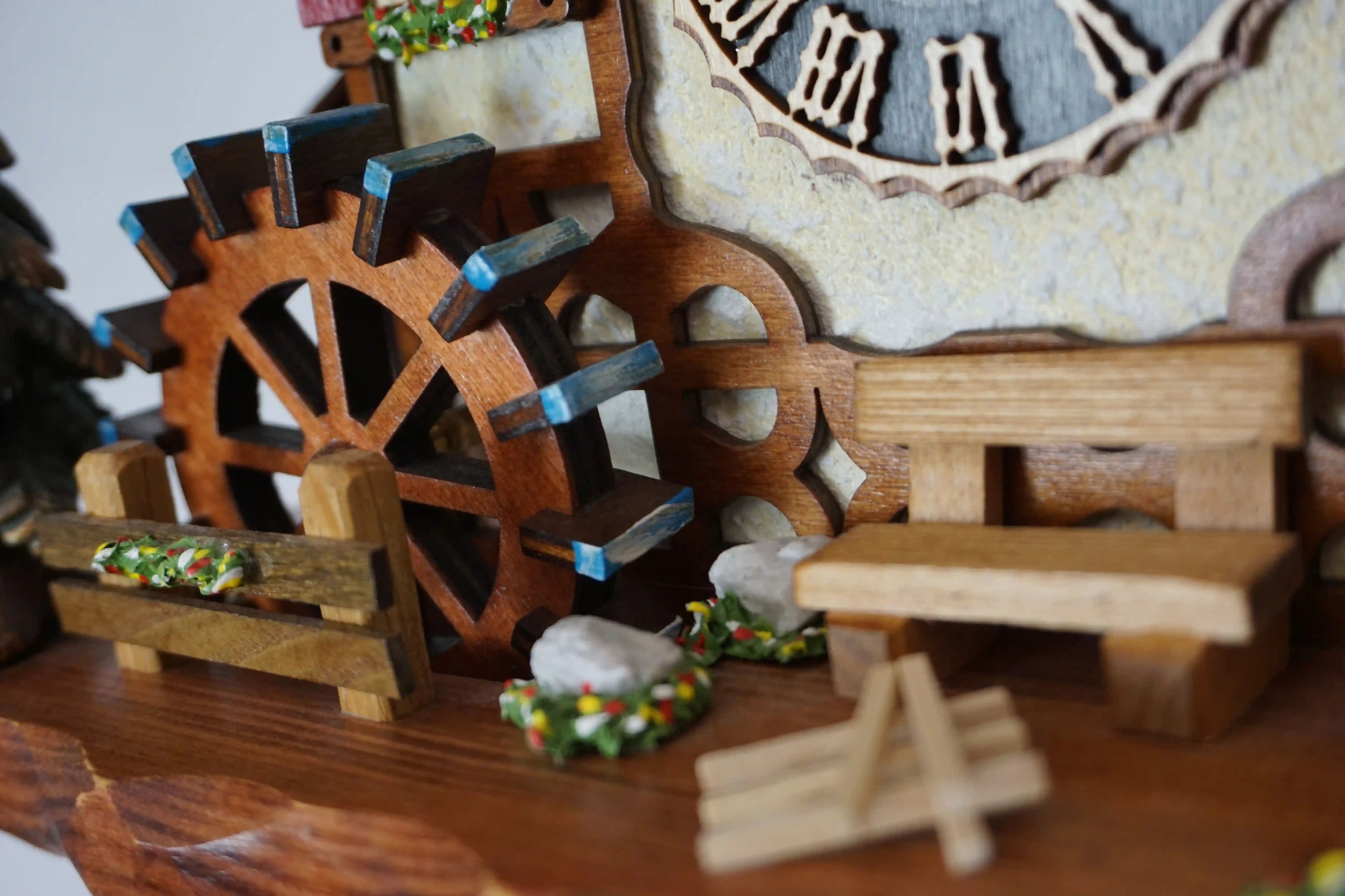 Cuckoo Clock  Kissing Kids  8 Day Movement with Music (7) Chalet shingle roof mechanical black forest cuckoo clock with presice attention to detail. The kids are turning their heads and kissing, water wheel turns and the dancers are dancing as the music is playing