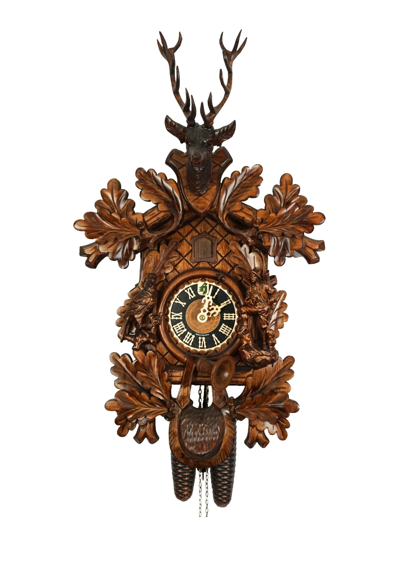Hand carved authentic mechanical brown black forest cuckoo clock in a hunter theme. Precisely carved deer head is decorating the top while there is a hunter and a falcon figure on the sides of the clock. The clocks dial is wraped with a hunting horn while