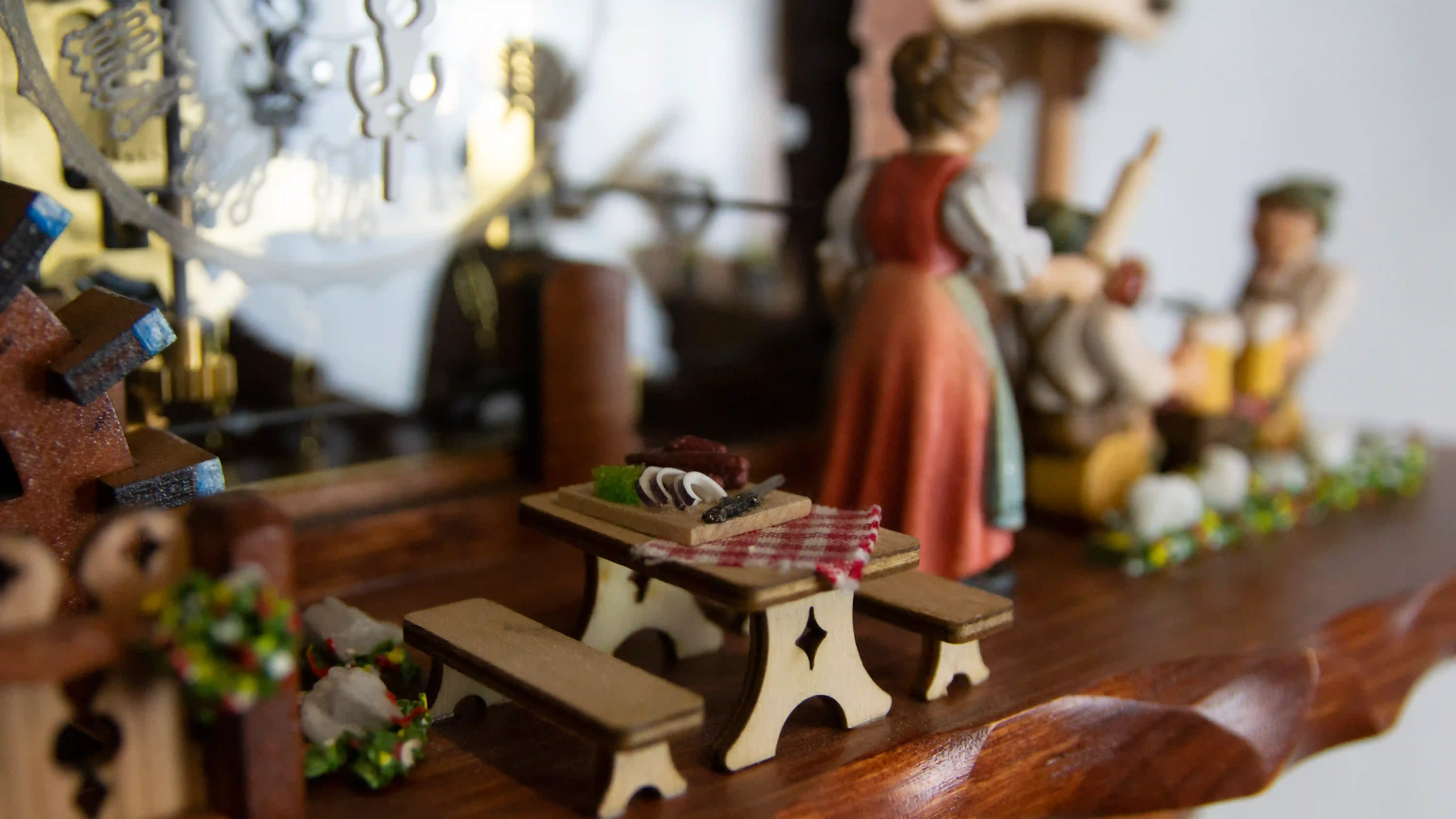 Cuckoo Clocks  Rolling Pan and Beer Drinkers  8 Day Movement with Music (6) Authentic mechanical large coloful black forest cuckoo clock with transparent plexiglass and visible inside movement. It displays two beer drinkers in the beer garden and the lady with a rolling pin. As the music is playing dancers dance, water wheel turn