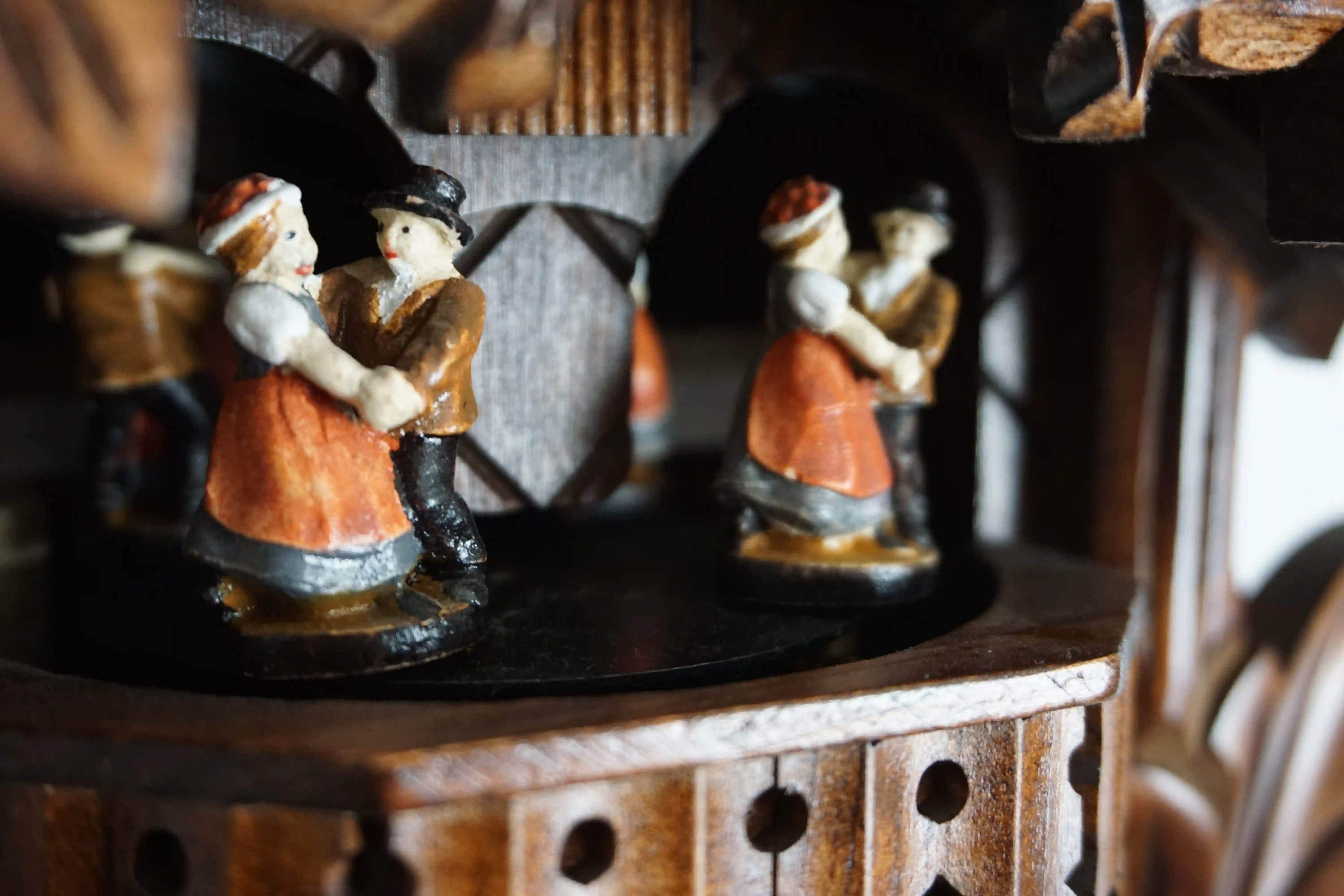 Cuckoo Clock  Traditional Style with Music  1 Day Movement   (4) Traditional stlye hard carved mechanical black forest cuckoo clock decorated with a carving of a cuckoo bird, plays music and has dancers made by Hönes