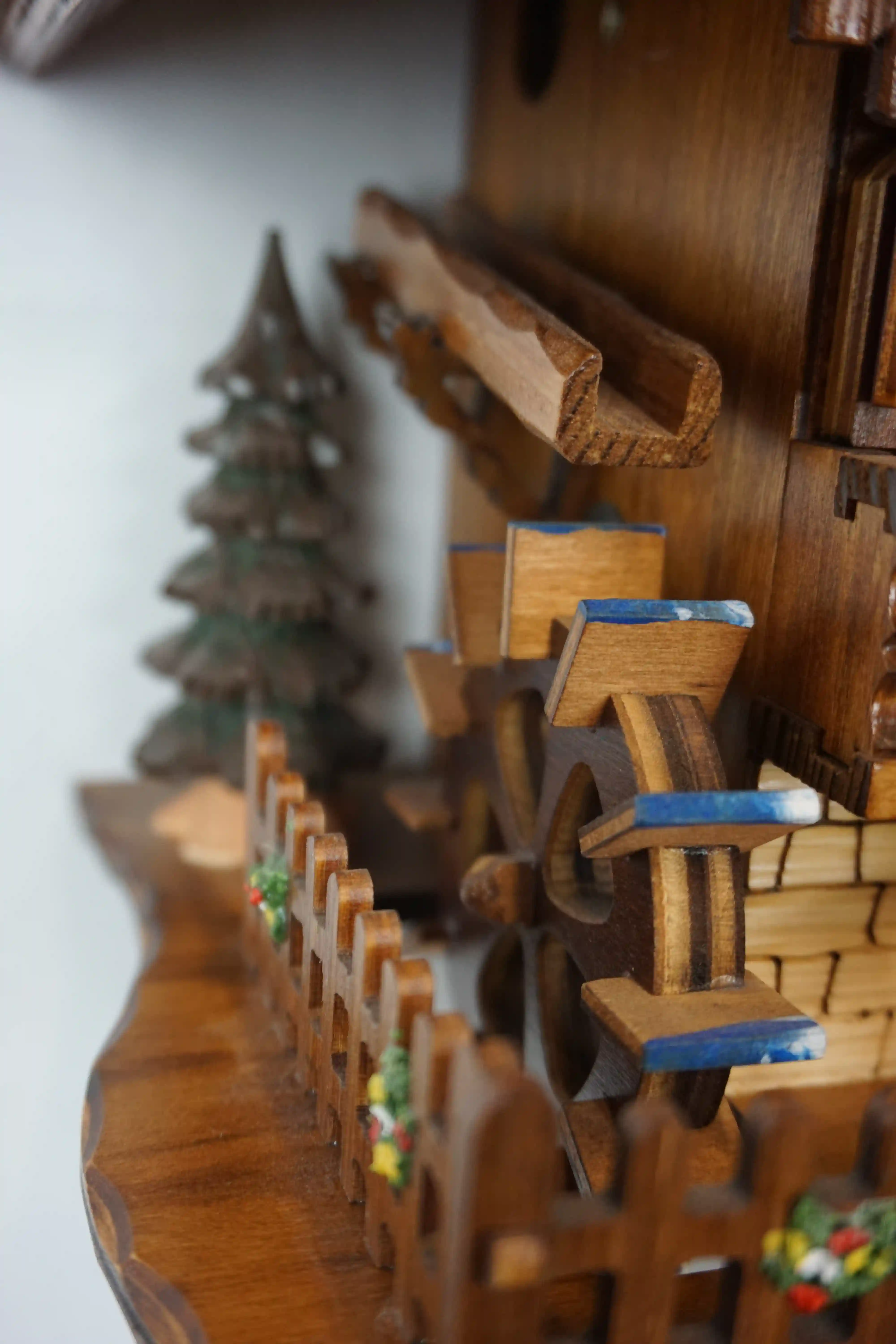 Cuckoo Clock  Honeymoon  1 Day Movement with Music (7) Mechanical black forest cuckoo clock decorated to the finest detail, representing a couple on honeymoon sitting on the bench in front of the chalet house sliding thowards each other for a kiss while the music plays, dancers and waterwheel turn