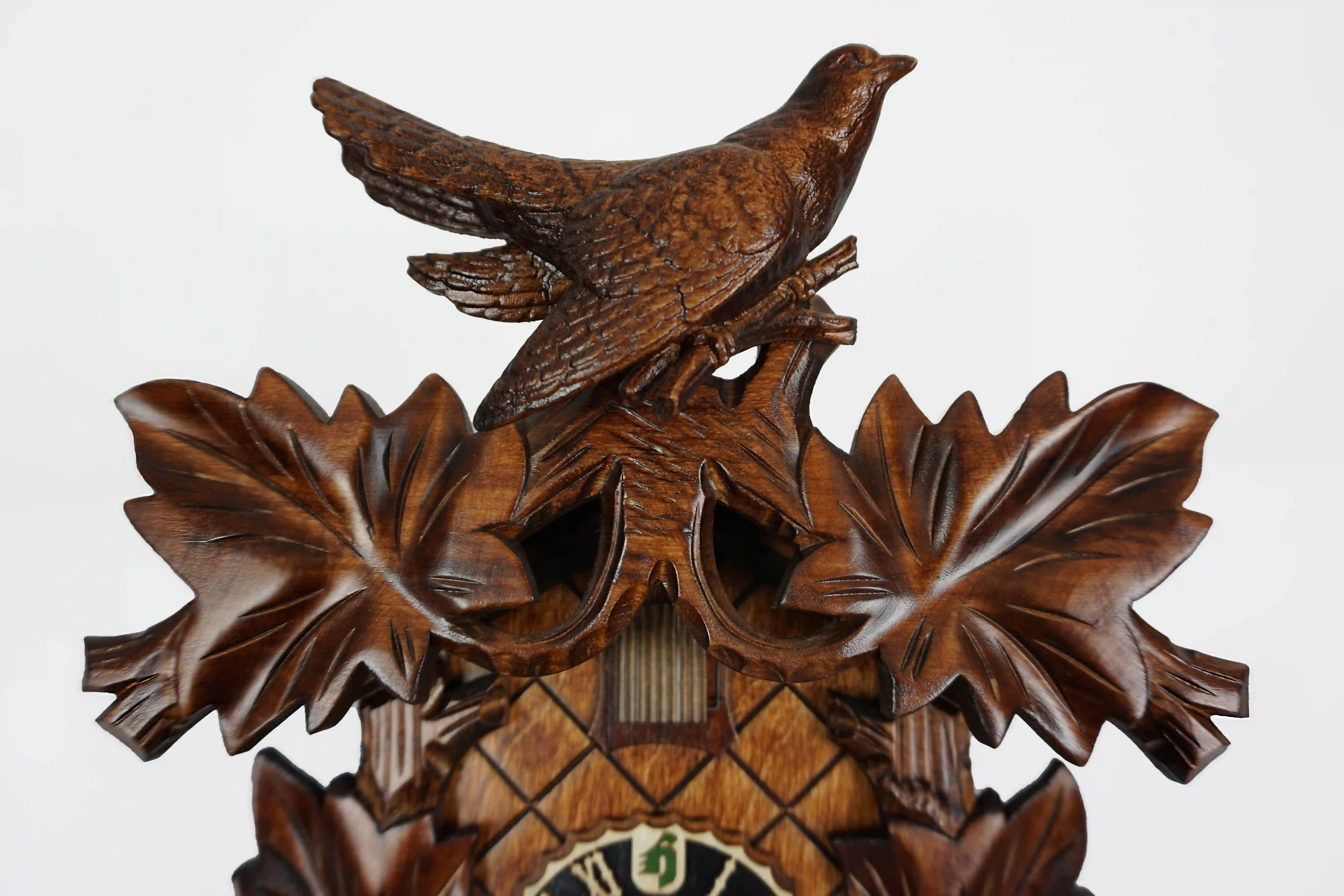 Cuckoo Clock  Traditional, Bird on Top  8 Day Movement (4) Traditional brown mechanical black forest cuckoo clock decorated with wine leave and very precisely carved cuckoo bird, made by Hönes
